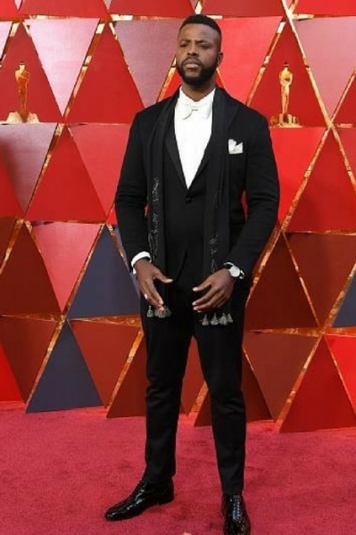 Black Panther actor Winston Duke in a tasseled black suit from Etro Image