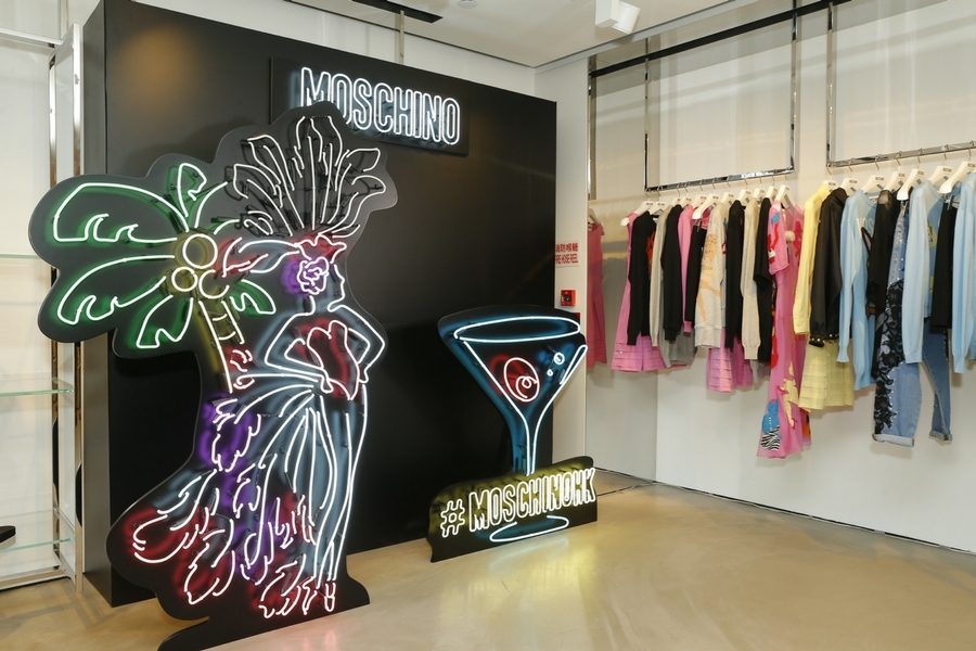 Moschino's store lighted up with a neon backdrop Image