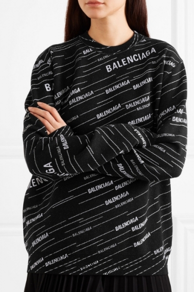 Balenciaga's oversized sweater looks so cool tucked into a pleated skirt Image