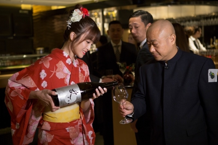Servers dressed in traditional kimonos welcomed guests with sake to the grand opening of Japanese restaurant FUMI in California Tower. Image